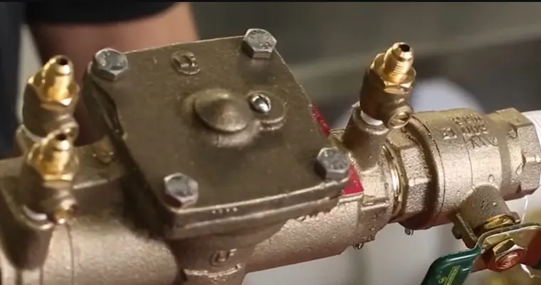 Backflow preventer assembly with test ports and valves for Backflow Preventer Testing in Tolleson: Annual Compliance Calendar for Commercial Properties The repair area is visible from a closer angle.