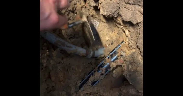 Under-slab plumbing repair area with concrete or soil opened for Caliche Soil and Hard Water: Why Slab Leaks Are More Common in Tolleson