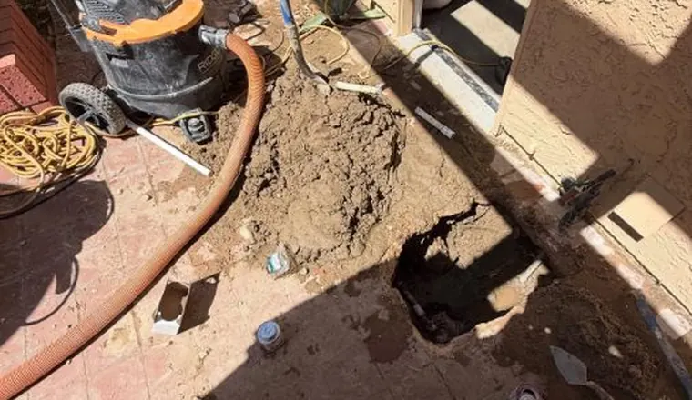Under-slab plumbing repair area with concrete or soil opened for Leak Detection in Tolleson, AZ The repair area is visible from a closer angle.